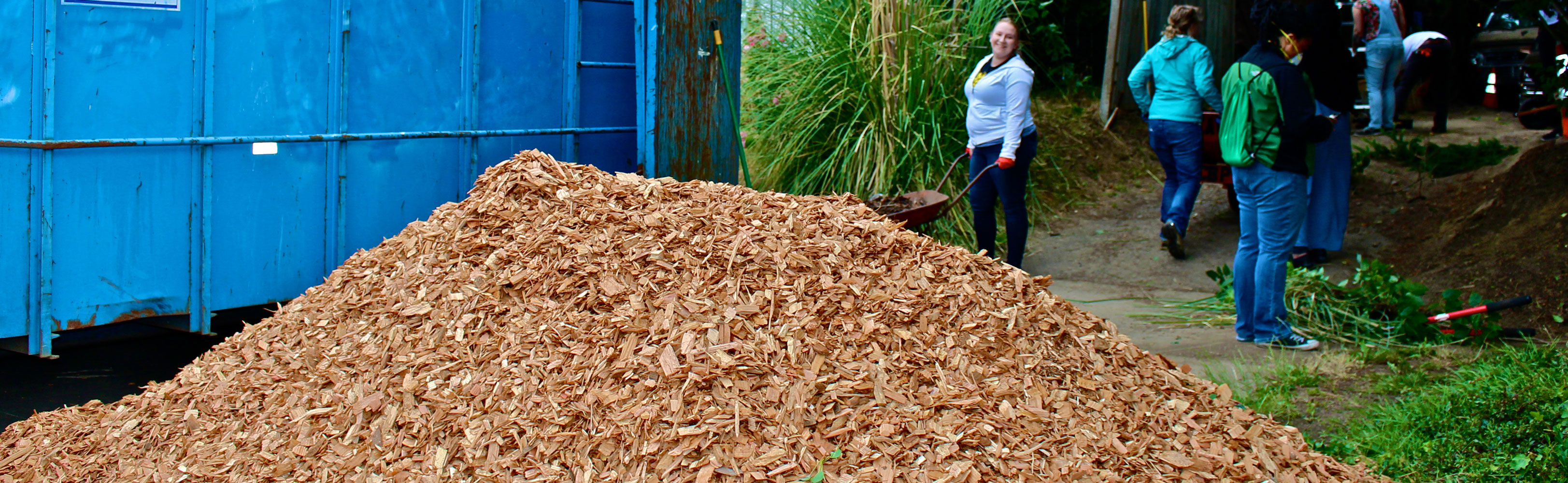 Two people boarding up a fence.